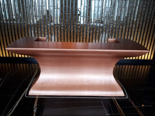 Project- Bluewaters Dubai; Finish Code - CU-0912; Finish - Copper Brushed Polished; Substrate; Wooden Resception Counter; Size - 2500mm X 1000mm X 1200mm
